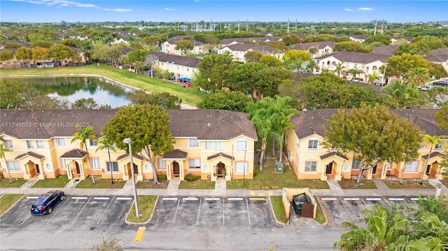 birds eye view of property with a water view and a residential view