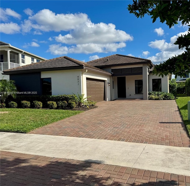 view of front of property with a front lawn and a garage