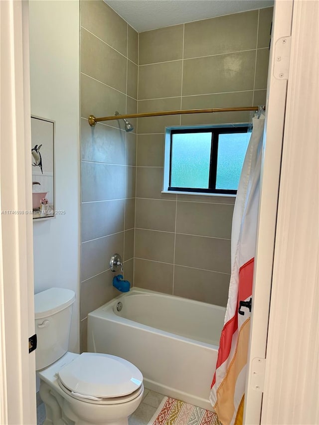 bathroom featuring toilet, tile patterned floors, and shower / bath combo with shower curtain