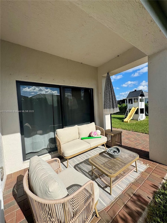 view of patio / terrace with a playground and an outdoor living space