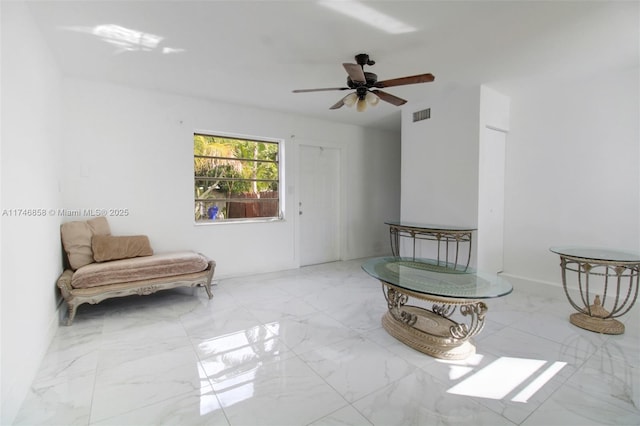 sitting room featuring ceiling fan