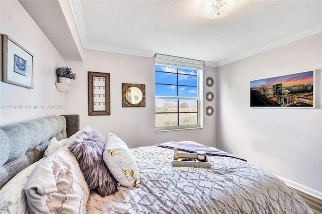 bedroom with crown molding, hardwood / wood-style floors, and a textured ceiling