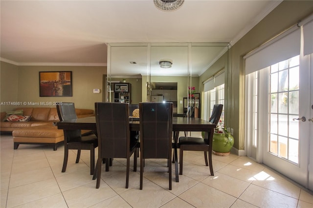 dining room with light tile patterned floors and ornamental molding