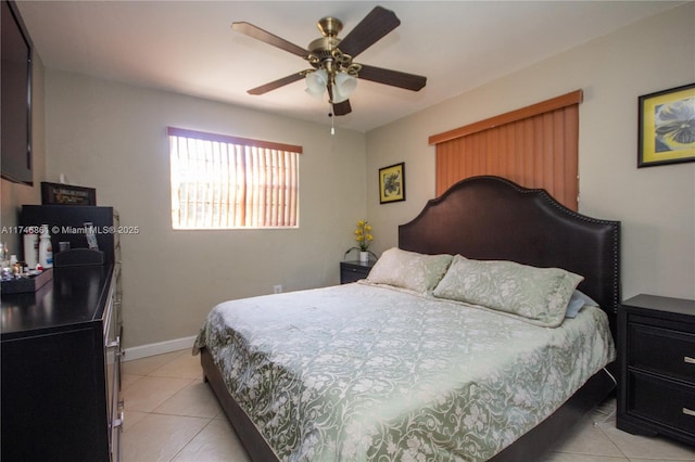 bedroom with a ceiling fan, baseboards, and light tile patterned floors