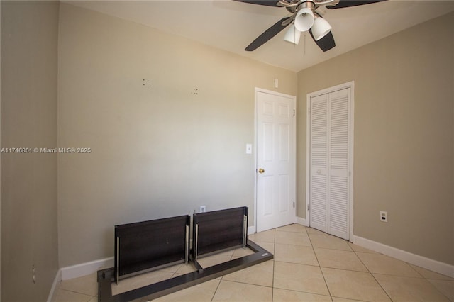 bedroom featuring a closet, tile patterned flooring, and baseboards