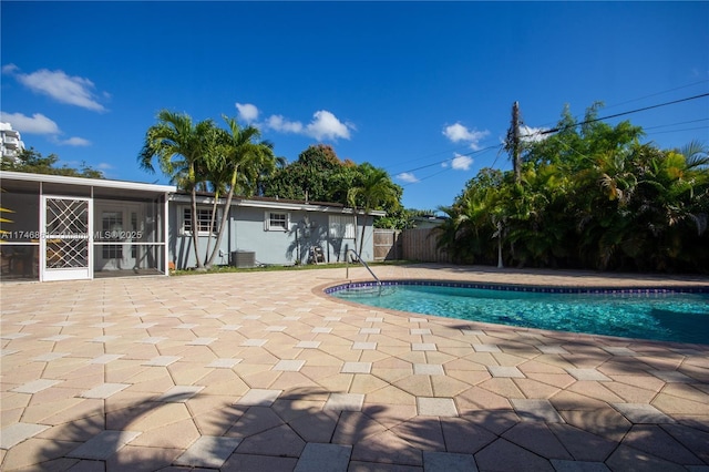view of pool featuring a fenced in pool, central AC, a patio, and fence
