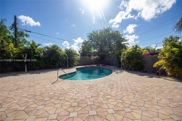 view of swimming pool featuring a patio area, a fenced backyard, and a fenced in pool