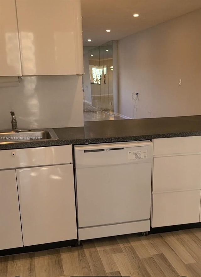 kitchen with white cabinets, light hardwood / wood-style floors, sink, and dishwasher