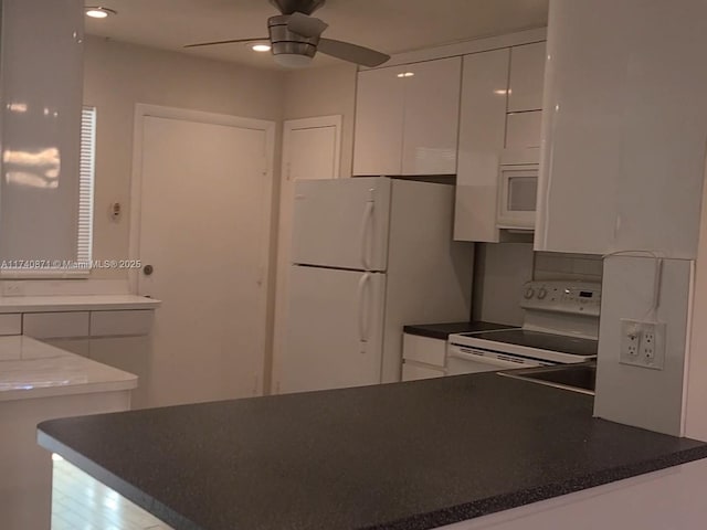 kitchen featuring ceiling fan, white appliances, kitchen peninsula, and white cabinets