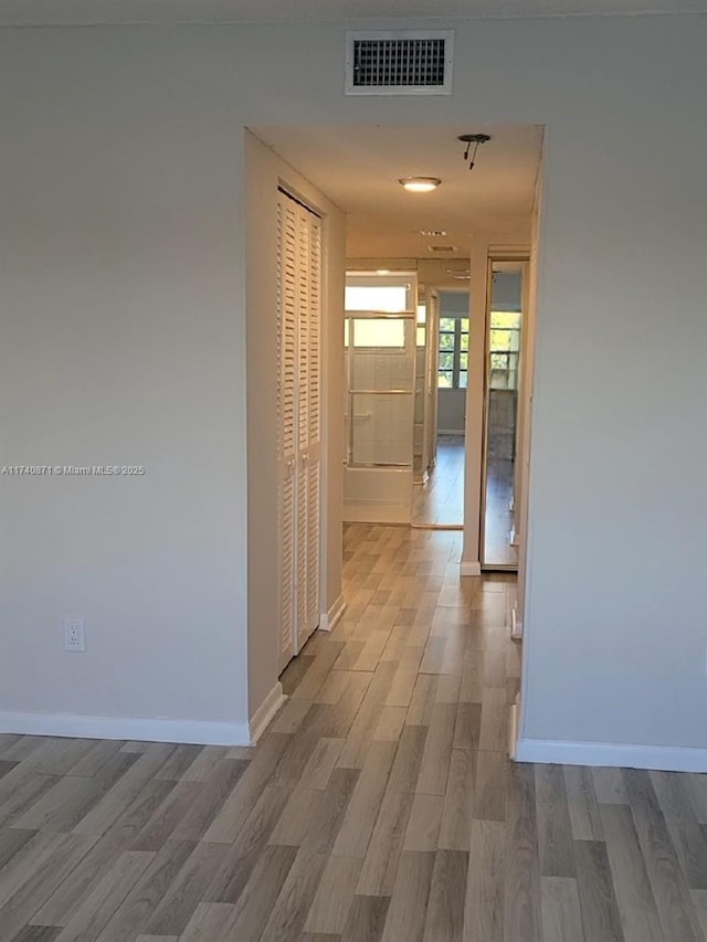 hallway featuring light hardwood / wood-style flooring