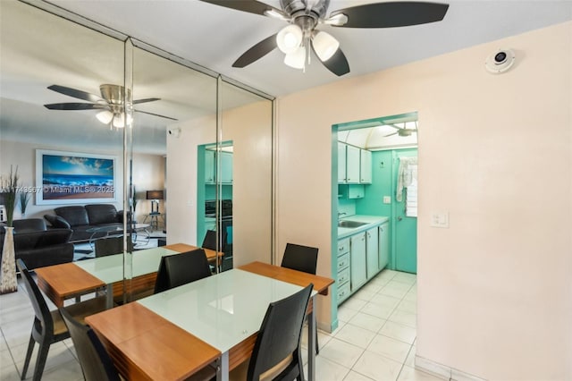 tiled dining room with sink and ceiling fan
