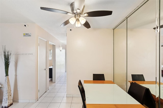 tiled dining area with ceiling fan