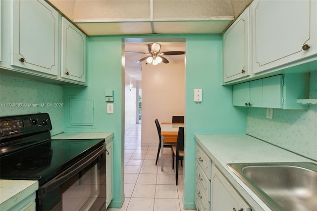 kitchen with black / electric stove, ceiling fan, sink, and white cabinets