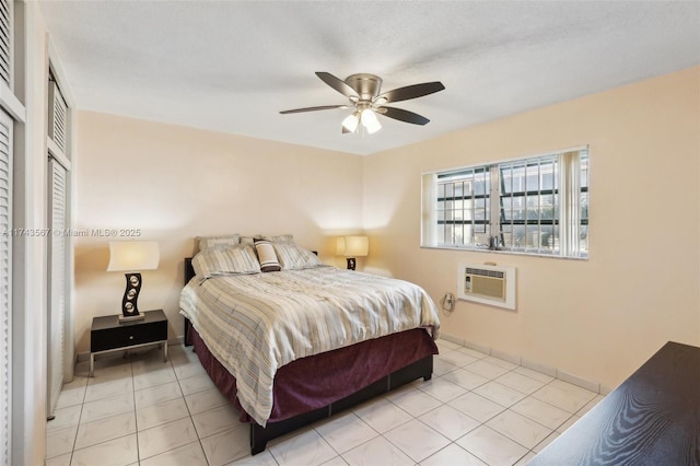 bedroom featuring light tile patterned flooring, an AC wall unit, and ceiling fan