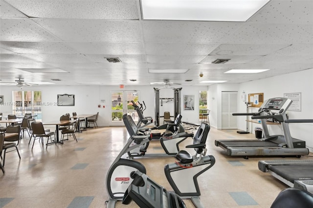 gym with a drop ceiling and ceiling fan