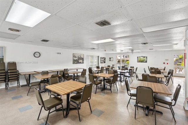 dining space with a drop ceiling