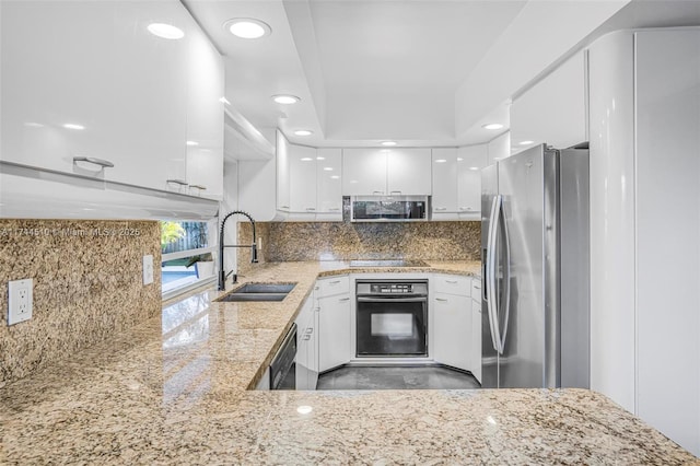 kitchen with white cabinetry, light stone countertops, sink, and black appliances