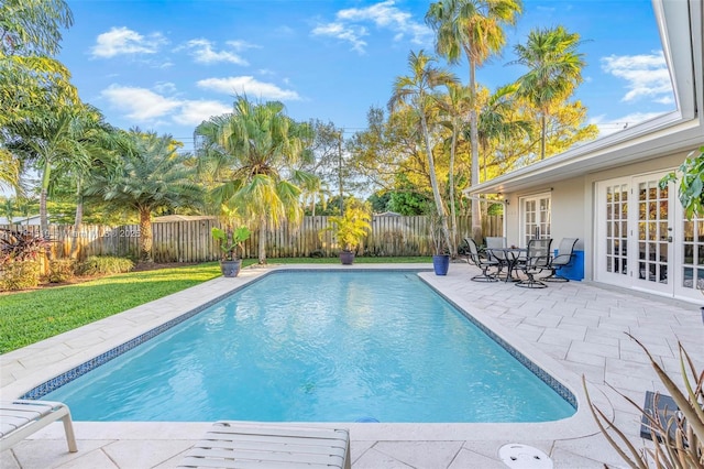 view of swimming pool featuring french doors and a patio