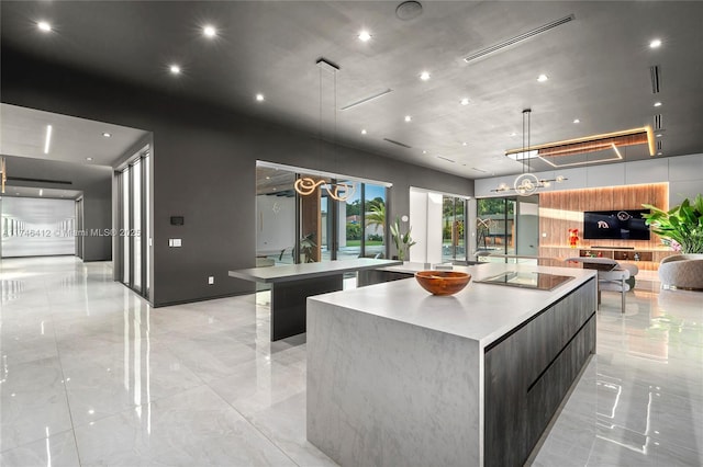 kitchen with hanging light fixtures, a large island, and black electric stovetop