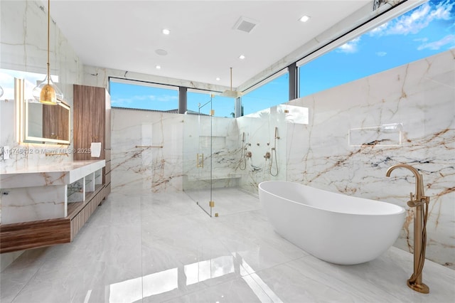 bathroom featuring vanity and shower with separate bathtub