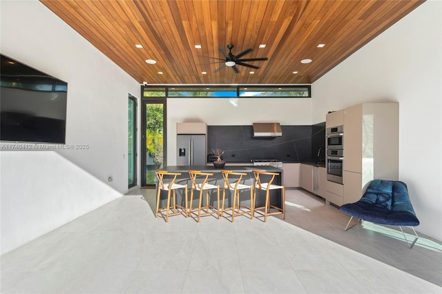 interior space with a wet bar and ceiling fan