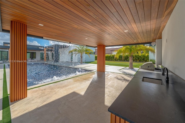 view of patio with a grill, exterior kitchen, and sink