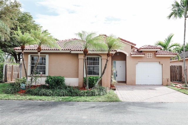 mediterranean / spanish home with a garage