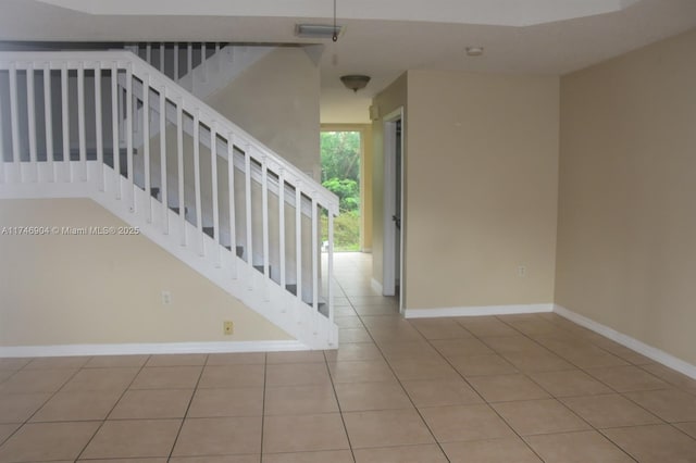 staircase with tile patterned floors