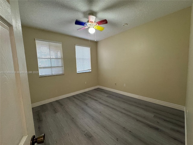 empty room featuring ceiling fan, wood-type flooring, and a textured ceiling