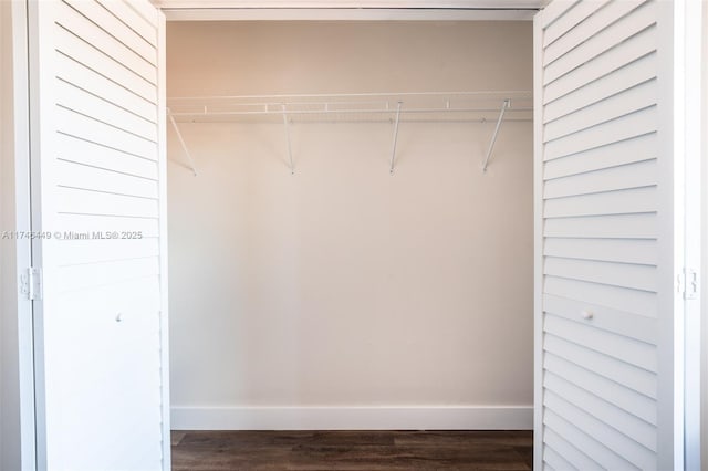 spacious closet featuring dark hardwood / wood-style flooring