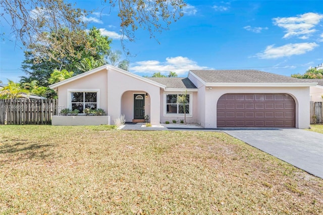 ranch-style house featuring a garage and a front lawn