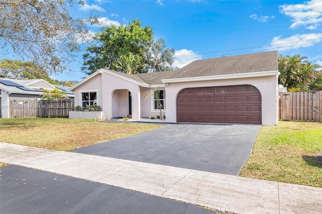 ranch-style home with a garage and a front yard