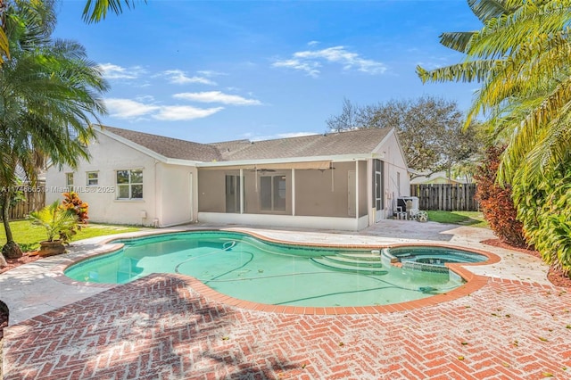 view of swimming pool featuring an in ground hot tub, ceiling fan, a sunroom, and a patio area