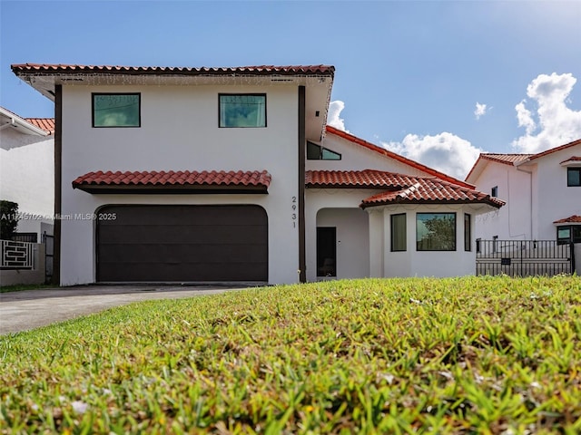 view of front of house featuring concrete driveway, a tile roof, and stucco siding