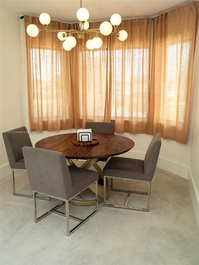 dining space featuring baseboards