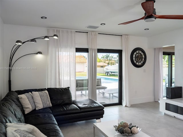 living area with baseboards, a ceiling fan, visible vents, and recessed lighting