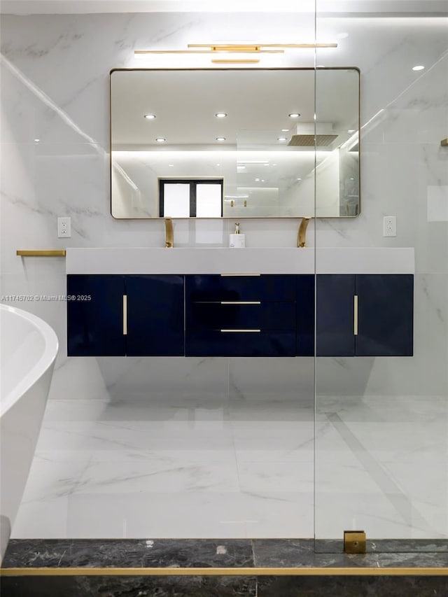 bathroom with a walk in shower, a freestanding bath, marble finish floor, and double vanity