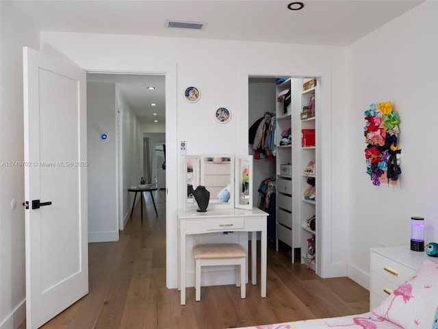 bedroom with a closet, light wood-type flooring, and visible vents