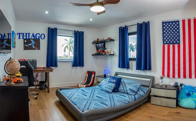 bedroom featuring ceiling fan, baseboards, wood finished floors, and recessed lighting