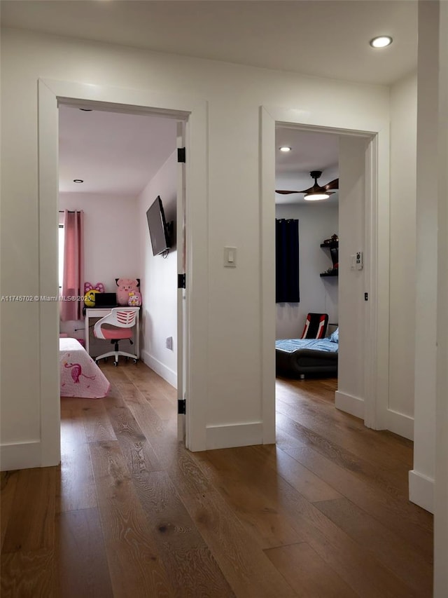 hallway featuring recessed lighting, baseboards, and hardwood / wood-style floors