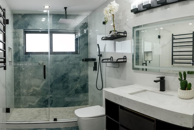 bathroom with vanity, a marble finish shower, and toilet