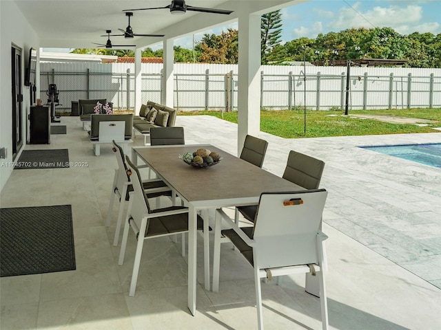 view of patio / terrace with a ceiling fan, outdoor dining space, a fenced backyard, and an outdoor hangout area