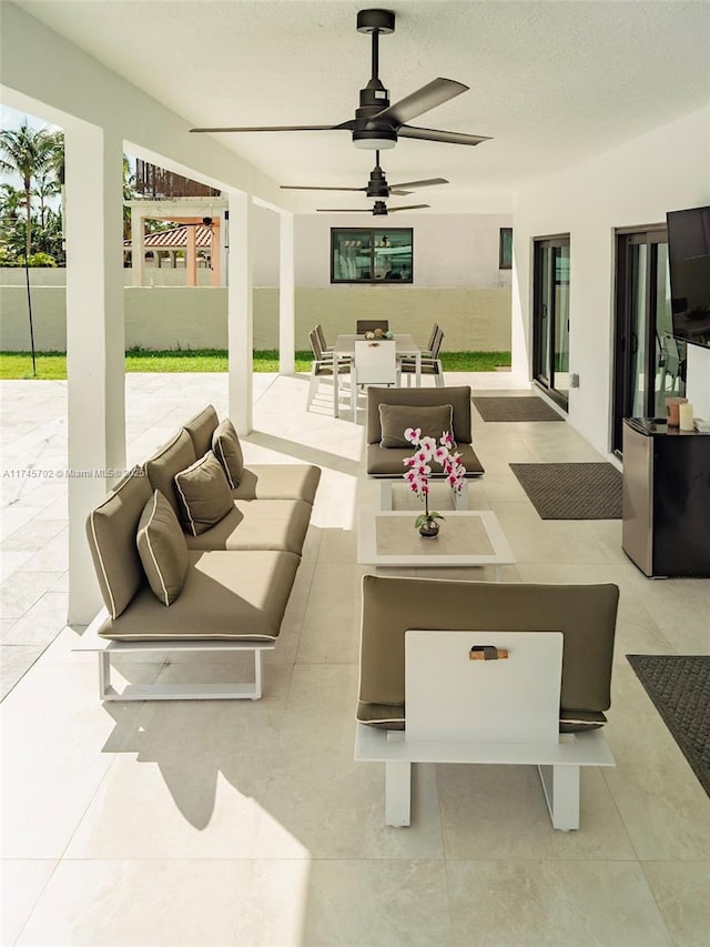 view of patio / terrace with a ceiling fan, outdoor dining space, and an outdoor living space