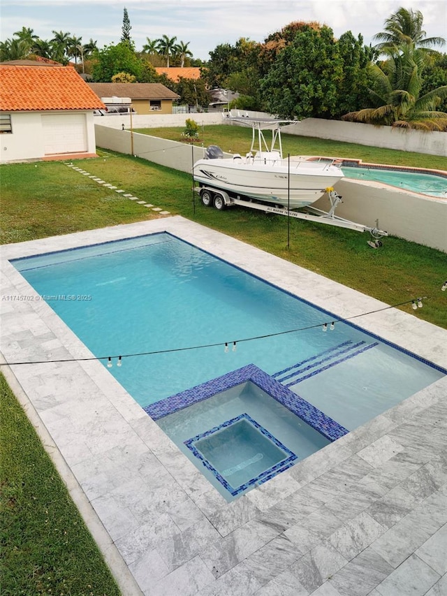 view of pool with a pool with connected hot tub and a lawn