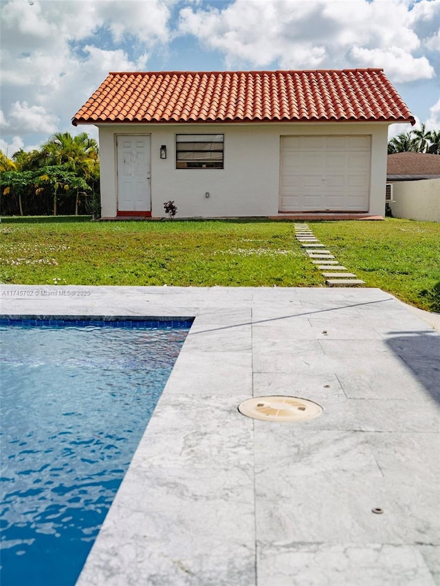 exterior space with a tiled roof, an outdoor pool, a lawn, and stucco siding