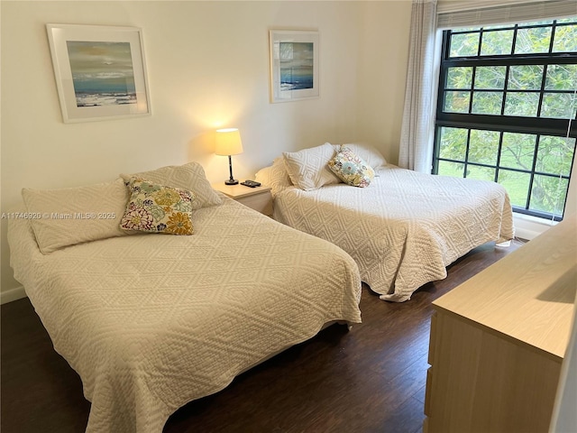 bedroom with dark wood-type flooring