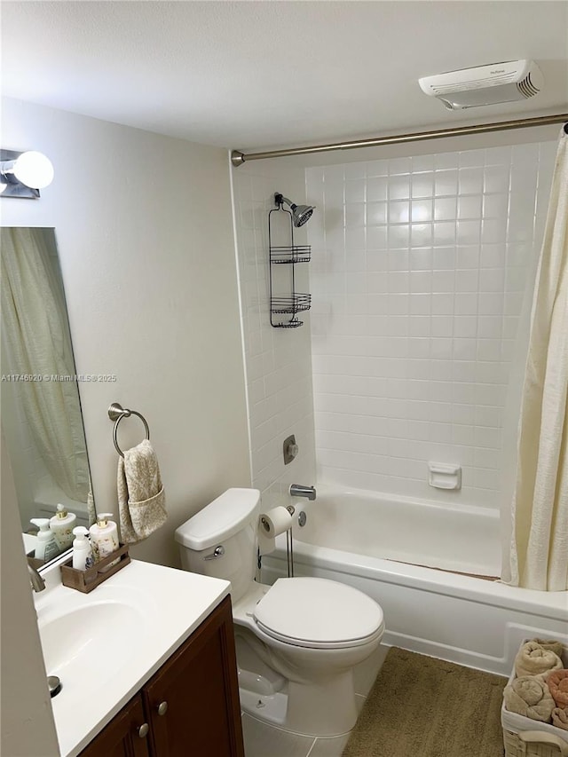 full bathroom with vanity, shower / bath combo, and toilet