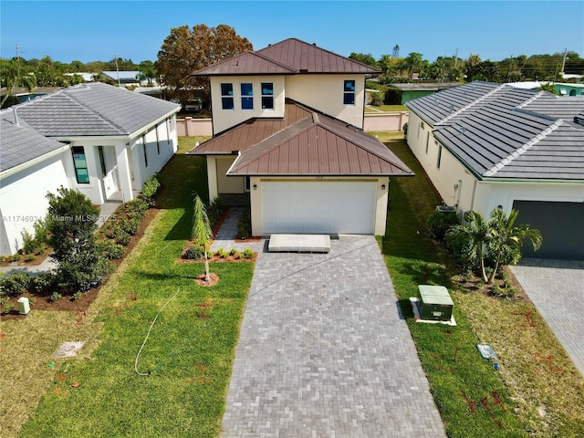 view of front of house with a garage and a front lawn