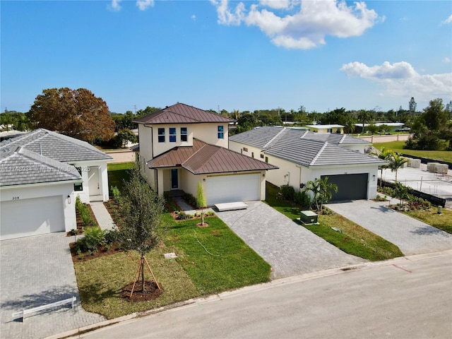312 SE Via Sangro Prt, St Lucie, FL 34952 - traditional home with stucco siding, a standing seam roof, a metal roof, a front yard, and decorative driveway