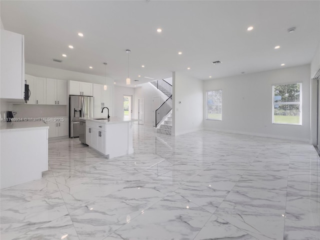 312 SE Via Sangro Prt, St Lucie, FL 34952 - kitchen featuring stainless steel appliances, open floor plan, light countertops, light marble finish flooring, and recessed lighting